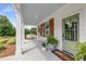 Inviting front porch with swing, rocking chairs, and a blue ceiling for a relaxing outdoor space at 300 Massengale Rd, Brooks, GA 30205