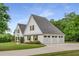 Three-car garage with white doors, surrounded by manicured landscaping and green grass at 300 Massengale Rd, Brooks, GA 30205