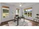 Home office with three windows overlooking the yard and a gray desk at 300 Massengale Rd, Brooks, GA 30205