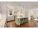 Bright kitchen featuring a green island with quartz countertops, hardwood floors and stainless appliances at 300 Massengale Rd, Brooks, GA 30205