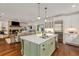 Open kitchen with a green island and stainless steel appliances, opening to the living room at 300 Massengale Rd, Brooks, GA 30205