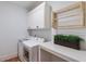 Bright laundry room featuring a front load washer and dryer, cabinets, and a countertop at 300 Massengale Rd, Brooks, GA 30205