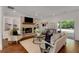 Cozy living room with brick fireplace, built-in shelving, and patio access to the backyard at 300 Massengale Rd, Brooks, GA 30205