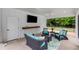 Stylish screened-in patio with comfortable seating, a TV, and a view of the outdoors at 300 Massengale Rd, Brooks, GA 30205