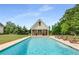 Stunning pool with crystal-clear water and inviting lounge chairs in a backyard setting at 300 Massengale Rd, Brooks, GA 30205