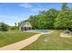 Relaxing backyard oasis with a sparkling pool, pool house, and lush landscaping at 300 Massengale Rd, Brooks, GA 30205
