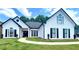 Beautiful white brick house with black trim, shutters, and a well-maintained lawn at 805 Doe Hill Ln, Roswell, GA 30075