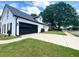 Attractive home exterior with a black garage door, well-manicured lawn, and established landscaping at 805 Doe Hill Ln, Roswell, GA 30075