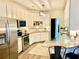 Modern kitchen with stainless steel appliances, white cabinets, and a breakfast bar at 805 Doe Hill Ln, Roswell, GA 30075