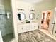 Bright bathroom featuring dual vanities, a glass-enclosed shower, and modern fixtures at 805 Doe Hill Ln, Roswell, GA 30075