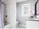 Clean bathroom with subway tile shower, white vanity, and black fixtures at 118 Wheelan School Rd, Dallas, GA 30157