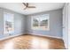 Bright, empty bedroom featuring hardwood floors and two windows with natural light at 118 Wheelan School Rd, Dallas, GA 30157