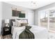 Cozy bedroom features ample natural light, comfortable bed with stylish decor, and access to an outdoor deck at 118 Wheelan School Rd, Dallas, GA 30157