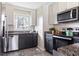 Updated kitchen with stainless steel dishwasher and microwave, black cabinets, and granite counters at 118 Wheelan School Rd, Dallas, GA 30157