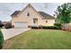 Backyard with a yellow two story home and an attached garage at 2726 Riderwood Ne Ln, Marietta, GA 30062