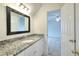 Bathroom with a granite countertop, white cabinets, and a framed mirror at 2726 Riderwood Ne Ln, Marietta, GA 30062