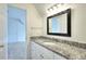 Bathroom featuring a vanity with a granite countertop and black framed mirror at 2726 Riderwood Ne Ln, Marietta, GA 30062