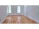 Minimalist bedroom featuring hardwood floors, white walls, and ample natural light from two windows at 2726 Riderwood Ne Ln, Marietta, GA 30062
