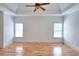 Bedroom featuring hardwood floors, a ceiling fan, and natural light from two windows at 2726 Riderwood Ne Ln, Marietta, GA 30062