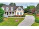 Beautiful two-story home showcasing a long driveway, lush landscaping, and a classic architectural design at 2726 Riderwood Ne Ln, Marietta, GA 30062