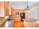 Kitchen featuring wooden cabinets, granite counters, island, and modern appliances at 2726 Riderwood Ne Ln, Marietta, GA 30062