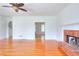 Bright living room with hardwood floors, brick fireplace, and modern ceiling fan at 2726 Riderwood Ne Ln, Marietta, GA 30062