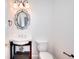 Stylish powder room with a pedestal sink, decorative mirror and toilet at 2726 Riderwood Ne Ln, Marietta, GA 30062