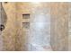 Modern shower with stylish tile, integrated shelving, and a built-in bench at 2726 Riderwood Ne Ln, Marietta, GA 30062