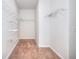 Walk-in closet with wall-mounted storage shelves and carpeting at 2726 Riderwood Ne Ln, Marietta, GA 30062