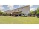 Spacious backyard showcasing a covered patio, lush lawn, and black wooden fence at 3985 Starwood Dr, Cumming, GA 30028