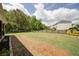 Large backyard with a well-manicured lawn, dark wooden fencing, and a view of the home's covered patio at 3985 Starwood Dr, Cumming, GA 30028