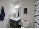 Cozy bathroom with dark vanity, tiled floor and a decorative shower curtain at 3985 Starwood Dr, Cumming, GA 30028