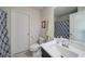 Bathroom with tiled floor, white fixtures, and a shower/tub with patterned curtain at 3985 Starwood Dr, Cumming, GA 30028