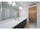 Well-lit bathroom featuring double sinks, a large mirror, and a shower with glass door at 3985 Starwood Dr, Cumming, GA 30028