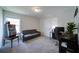 Comfortable bedroom with grey sofa, computer desk, and a vintage arcade game at 3985 Starwood Dr, Cumming, GA 30028
