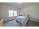 Bright bedroom has a comfortable bed and lots of natural light from a large window at 3985 Starwood Dr, Cumming, GA 30028