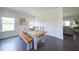 Bright dining area with hardwood floors, modern lighting, and wainscoting detail, open to the living area at 3985 Starwood Dr, Cumming, GA 30028