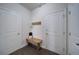 Entryway features a wooden bench and a coat rack between two white doors at 3985 Starwood Dr, Cumming, GA 30028