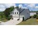 Aerial shot of a two-story home with a well-kept lawn, mature landscaping and three-car garage at 3985 Starwood Dr, Cumming, GA 30028