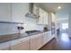 Modern kitchen with white cabinets, granite countertops, and stainless steel appliances, open to dining area at 3985 Starwood Dr, Cumming, GA 30028