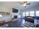 Living room features a fireplace, large TV, and built-in shelves with a ceiling fan at 3985 Starwood Dr, Cumming, GA 30028