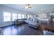 Open living area boasts large windows, a sectional sofa, and views to the dining room and kitchen at 3985 Starwood Dr, Cumming, GA 30028