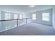 Bright loft area with new carpet, natural light and classic railing overlooking the level below at 3985 Starwood Dr, Cumming, GA 30028