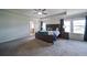 Spacious main bedroom with a tray ceiling, large windows, and a comfortable king-sized bed at 3985 Starwood Dr, Cumming, GA 30028