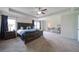 Spacious main bedroom featuring a ceiling fan, carpeted floors, and a sitting area at 3985 Starwood Dr, Cumming, GA 30028