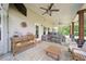 Inviting covered patio with stone floors and comfortable lounge seating; ideal for relaxation and outdoor entertaining at 3985 Starwood Dr, Cumming, GA 30028