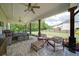 Covered patio with stone flooring, comfortable seating, and outdoor dining area overlooking the yard at 3985 Starwood Dr, Cumming, GA 30028