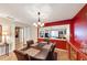 Elegant dining room with chandelier, wood floors, and pass-through to a well-lit living room, great for entertaining at 4118 Stillwater Dr, Duluth, GA 30096