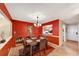 Inviting dining room features a stylish chandelier and red accent wall, creating a warm and elegant atmosphere at 4118 Stillwater Dr, Duluth, GA 30096
