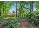 Lush backyard filled with trees and shrubs providing shade and privacy at 404 Carryback Dr, Marietta, GA 30068